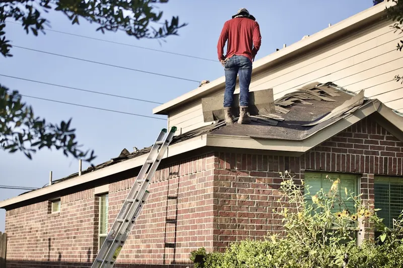 Professional roofer working on a residential roof in North City Farms